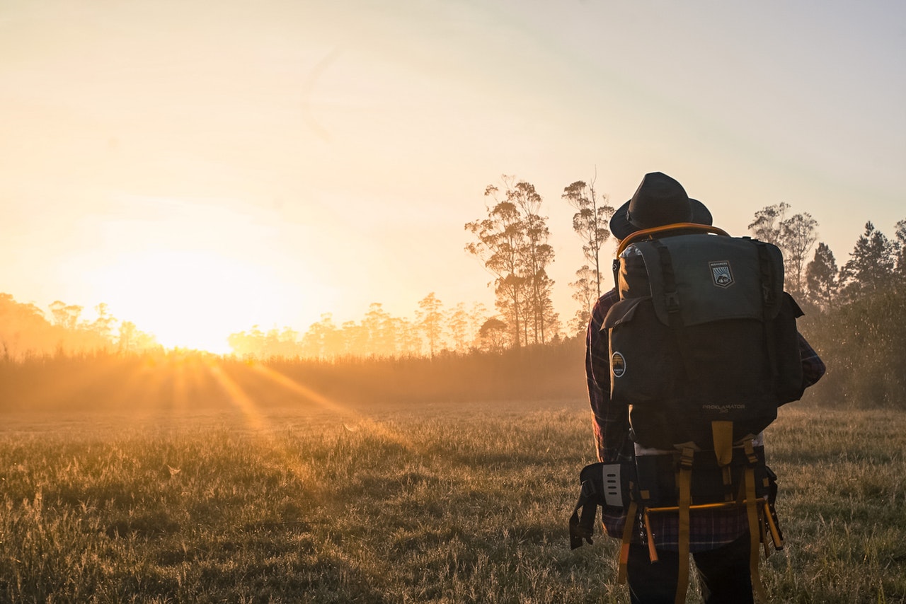 Man wearing backpack trying to decide which direction to go