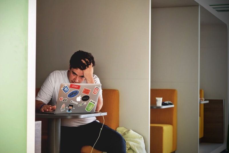 frustrated guy at a computer Photo by Tim Gouw from Pexels