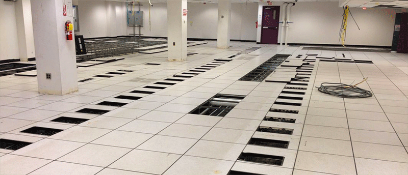 Empty Data Room with racks removed and floor tiles pulled
