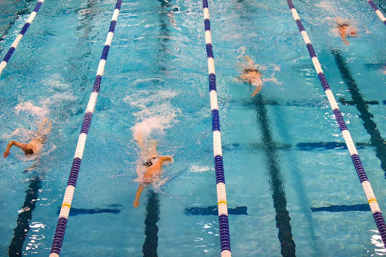 top down picture of swimming competition highlighting the distinct swimlanes in a swimming pool